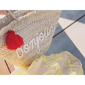 Women&#039;s handmade summer beach straw bag with letters graphic and tassel charm