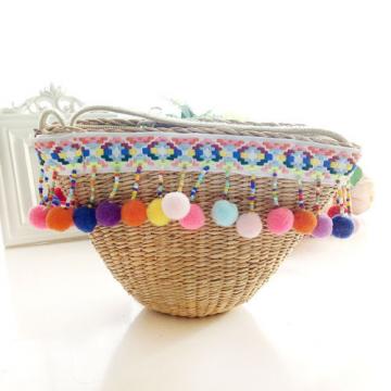 Women&#039;s handmade woven summer beach mini straw bag with pom pom beads tassels