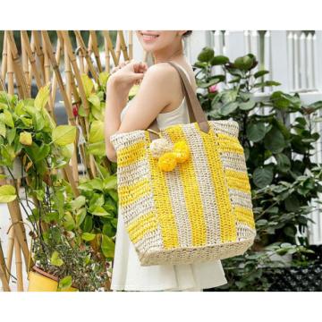 Women&#039;s handmade summer beach large straw bag with stripe design and pom poms