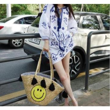 Women&#039;s handmade summer beach large straw bag with cute smile face and tassels