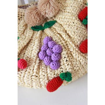 Women&#039;s handmade large summer beach straw bag with crocheted fruits and pom pom