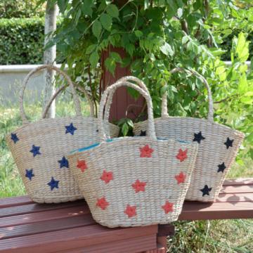 Women&#039;s handmade summer beach straw bag with star embroidery design