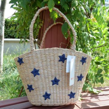 Women&#039;s handmade summer beach straw bag with star embroidery design