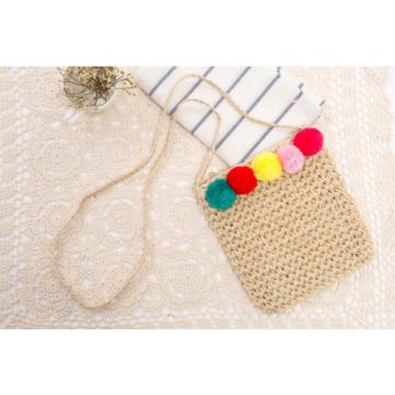 Women&#039;s handmade summer beach small straw cross body bag with colorful pom poms