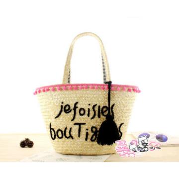 Women&#039;s handmade woven summer beach straw bag with pom poms emboridery tassel