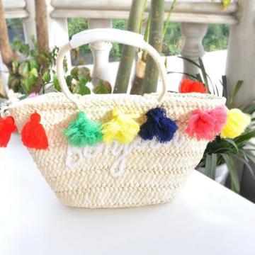 Women&#039;s handmade summer beach straw bag with colorful tassels and letter graphic