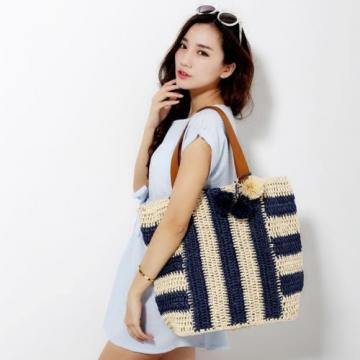 Women&#039;s handmade summer beach large straw bag with stripe design and pom poms