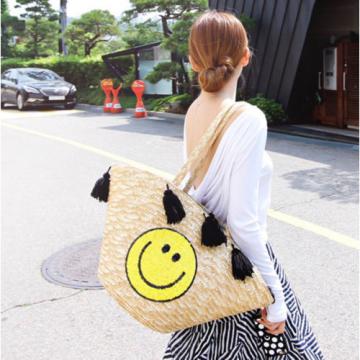 Women&#039;s handmade summer beach large straw bag with cute smile face and tassels