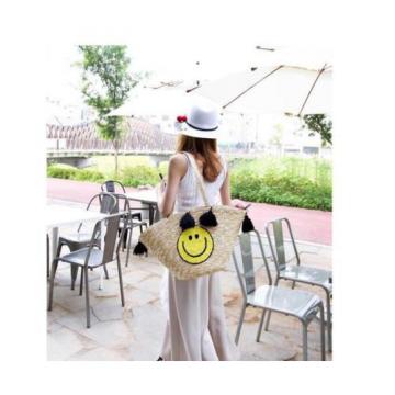 Women&#039;s handmade summer beach large straw bag with cute smile face and tassels