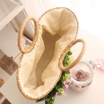 Women&#039;s handmade summer beach straw round bag with artificial flowers blossoms