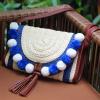 Women&#039;s handmade straw clutch bag handbag with pom poms and tassel