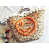 Women&#039;s handmade summer beach straw bag with pom pom emoji smile and sequin star