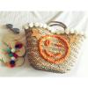 Women&#039;s handmade summer beach straw bag with pom pom emoji smile and sequin star