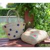 Women&#039;s handmade summer beach straw bag with star embroidery design