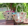 Women&#039;s handmade summer beach straw bag with star embroidery design