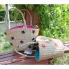 Women&#039;s handmade summer beach straw bag with star embroidery design