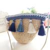 Women&#039;s handmade woven summer beach mini straw bag with pom pom beads tassels