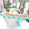 Women&#039;s handmade summer beach big straw bag with pink mint pom pom star print