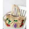 Women&#039;s handmade large summer beach straw bag with crocheted fruits and pom pom