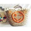 Women&#039;s handmade summer beach straw bag with pom pom emoji smile and sequin star